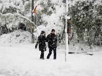A couple are walking in the snow in Athens, Greece, on February 16, 2021. The snowfall called 'Medea' showed up in the area of Zografou in A...