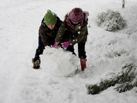 Children are playing with the snow in Athens, Greece, on February 16, 2021. The snowfall called 'Medea' showed up in the area of Zografou in...
