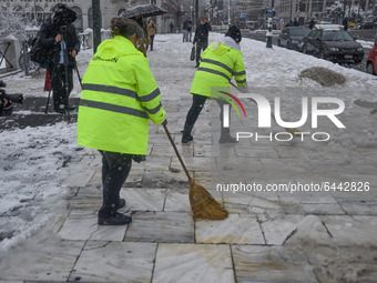 Municipal workers , the syntagma square, in the center of Athens, during a rare heavy snowfall in the city on February 16, 2021. (