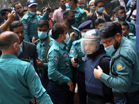 Police escort a convicted man after a Bangladesh anti-terrorism court sentenced five Islamist extremists to death over the brutal murder of...