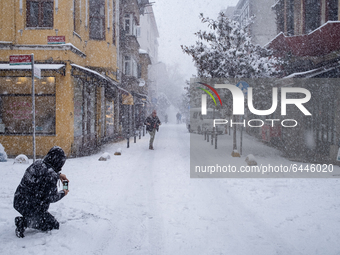 A man taking a photo of the streets during a heavy snow storm in the Kadikoy district of Istanbul, Turkey early in the morning on February 1...