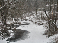 Partially frozen stream in a park as a snowstorm dropped 10-15 centimeters of snow across the city of Toronto, Ontario, Canada, on February...