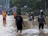 A motorbike rider guides his vehicle on a flooded road in Jakarta, Indonesia, Saturday 20 February 2021. Heavy rains combined with poor muni...