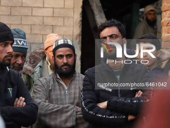Villagers are seen outside the house of Abdul Wahid who died due to forest fire in Sultan Daki, Uri Baramulla on 21 February 2021.  
On Feb...