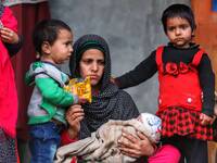 Wife of Abdul Wahid along with her 4 Kids outside their house in Sultan Daki, Uri Baramulla on 21 February 2021.  
On February 7, fire brok...