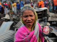 An elderly slum dweller mourns in front of her burnt home n Dhaka, Bangladesh on February 21, 2021. At least 200 shanties were gutted in the...