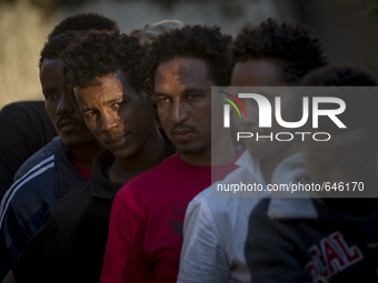 Refugees ready to eat outside the Humanitarian emergency reception centre for immigrants, Baobab, close Tiburtina train station in Rome, Ita...