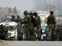 Indian soldiers escort a member of bomb disposal squad at Patha Chowk-Nowgam road in Srinagar,Kashmir on February 22, 2021.An Improvised Exp...