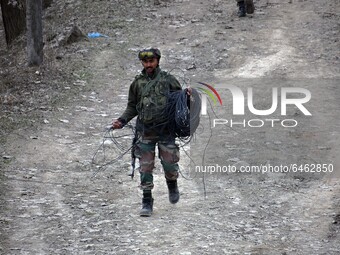 An Indian soldier walks after an Improvised Explosive Device (IED) was diffused at Patha Chowk-Nowgam road in Srinagar,Kashmir on February 2...