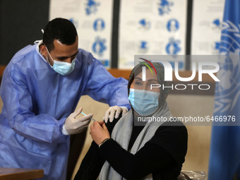 A Palestinian UNRWA employee, receives a vaccine against the coronavirus disease (COVID-19) at a United Nations-run clinic in Gaza City Febr...