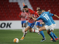 Jorge Molina of Granada and Nikola Maksimovic of Napoli compete for the ball during the UEFA Europa League Round of 32 match between Granada...