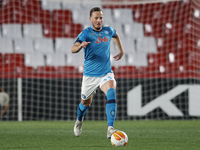 Amir Rrahmani of Napoli runs with the ball during the UEFA Europa League Round of 32 match between Granada CF and SSC Napoli at Estadio Nuev...