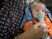 A baby who is suffering from respiratory disease receives treatment inside at Dhaka Shishu (Children) Hospital in Dhaka, Bangladesh on Febru...