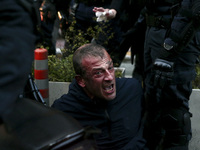 Greek police officers arrest a protester during a demonstration in support to Dimitris Koufontinas, the jailed hitman of the now defunct Nov...