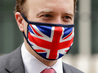 Secretary of State for Health and Social Care Matt Hancock, Conservative Party MP for West Suffolk, wears a Union Jack face mask leaving 10...