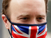 Secretary of State for Health and Social Care Matt Hancock, Conservative Party MP for West Suffolk, wears a Union Jack face mask leaving 10...