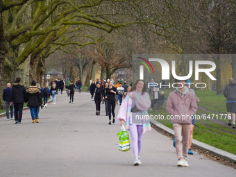 Members of the public walk through  Victoria Park, East London this afternoon on 26 February 2021. (