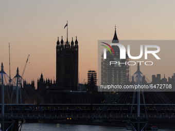 LONDON, UNITED KINGDOM - FEBRUARY 26, 2021: A view of the Victoria Tower, Big Ben and River Thames during sunset after a warm and clear spri...