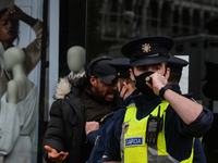 Members of Garda (Irish Police) clash with protesters or passers during Anti-Lockdown protest outside Saint Stephen's Green entrance, during...