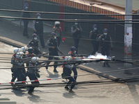 Riot police fire tear gas at protesters during a violent crackdown on demonstrations against the military coup in Yangon, Myanmar on Februar...