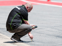 A member of the Kawasaki team, monitors the temperature of the asphalt during the SBK Qualifying Practice in the FIM CEV Repsol 2015 which w...