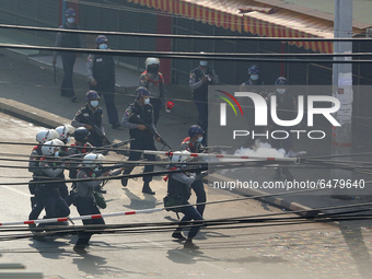 Riot police fire tear gas at protesters during a violent crackdown on demonstrations against the military coup in Yangon, Myanmar on Februar...