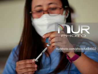 A nurse prepares to administer the Sinovac COVID19 vaccine during a ceremonial vaccination program held inside a sports stadium in Marikina...