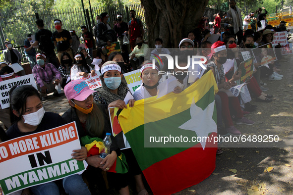 Chin refugees from Myanmar hold placards as they shout slogans during a protest against the military coup in Myanmar, in New Delhi, India on...