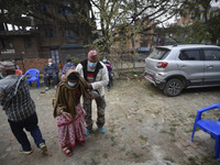 A family member helps to bring Nepalese People above 65 to get first dose of COVID19 vaccines developed by Oxford- AstraZeneca Plc at Bal Ku...