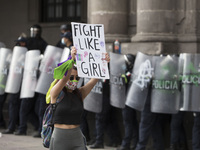 A women confront a police line  during the riots caused for the protests  against gender violence as part of  the commemoration of   Interna...