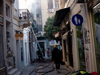 Fire extinguishing at a building in Perikleous street in the center of Athens, Greece, March 12, 2021. (