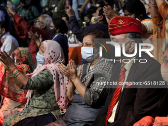 People with covered faces as a precautionary measure against COVID-19, attend an event titled 'Freedom@75' to commemorate the 75th year of I...