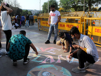 Activists participate in a street art campaign to raise awareness on climate change, at Connaught Place in New Delhi, India on March 14, 202...