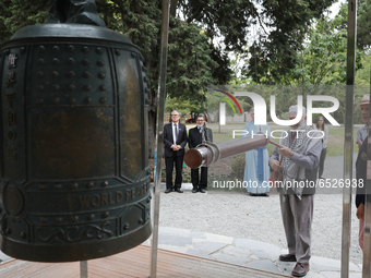 A member of the Muslim community rings New Zealand's only World Peace Bell during a ceremony at the Botanic gardens in Christchurch, New Zea...