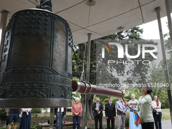 A member of the public rings New Zealand's only World Peace Bell during a ceremony at the Botanic gardens in Christchurch, New Zealand, on M...