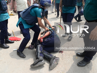 A Policeman injured during clashes between garment workers and police in Dhaka, Bangladesh, on March 16, 2021. Garments workers of Stitch We...
