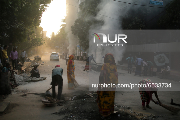 Construction workers working on a road that creates toxic smoke in Dhaka, Bangladesh on March 17, 2021. Air pollution consistently ranks amo...