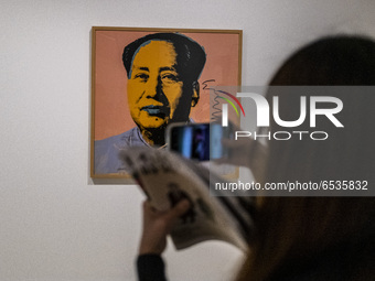 A Women takes a photo of a painting of Former Chairman of the People's Republic of China Mao Zedong inside the ‘Not a Fashion Store’ art exi...