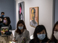People wall pass a painting of Former Chairman of the People's Republic of China Mao Zedong inside the ‘Not a Fashion Store’ art exibition i...