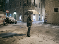 People  during the snowfall that hit central Italy. L'Aquila, Italy, on 18 March 2021. (