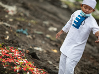 A child cried in front of his grandma grave. Burrial process of a victim of Covid19 at Srengsawah, South Jakarta, Indonesia on March 19, 202...