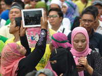 MANILA, Philippines - A muslim woman snaps a photo of the event as Filipino Muslims take part in a rally as they celebrate in Mendiola bridg...