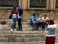 Two Egyptian girls pose while a friend makes a photograph on Al Moe'z Street near Al Hussein Mosque in Old Cairo, Egypt. Thursday, March 20t...