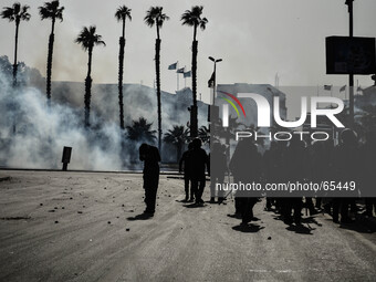 Cairo university students clash with riot police in front of the university. The police fired tear gas and students threw stones and firewor...