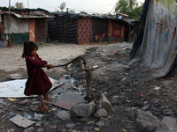 A girl tries to draw water from a handpump at a slum area on World Water Day in New Delhi, India on March 22, 2021.  (