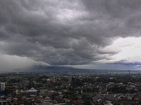 Black clouds cover Bogor, West Java, Indonesia, on March 24, 2021. The Meteorology, Climatology and Geophysics Agency (BMKG) predicts that t...
