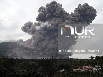 Mount Sinabung spews volcanic ash giant spitting into the sky, as seen covering the Tiga Pancur village, Karo, North Sumatra, Indonesia on J...