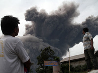 Villagers saw Mount Sinabung spews volcanic ash giant spitting into the sky, as seen covering the Tiga Pancur village, Karo, North Sumatra,...