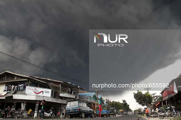Villagers covered above clumps Mount Sinabung spews volcanic ash giant spitting into the sky, as seen covering the Simpang Empat village, Ka...