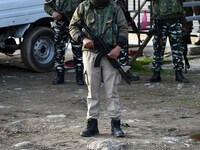Indian soldiers stand near the spot where suspected militants carried an attack on Indian paramilitary forces in Lawaypora on Srinagar outsk...